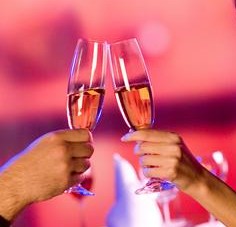 couple clinking champagne over dinner (Small)